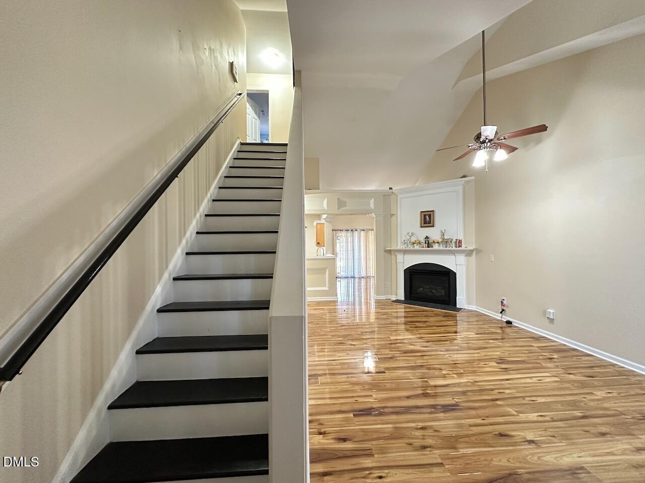2125 Star Sapphire Drive Raleigh, NC 27610 - Photo 3 of 25 a view of a livingroom with fireplace stairs and windows
