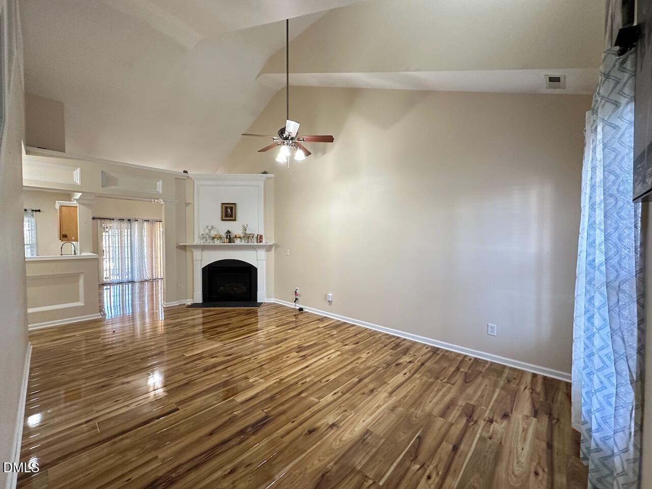 2125 Star Sapphire Drive Raleigh, NC 27610 - Photo 5 of 25 a view of empty room with fireplace and wooden floor
