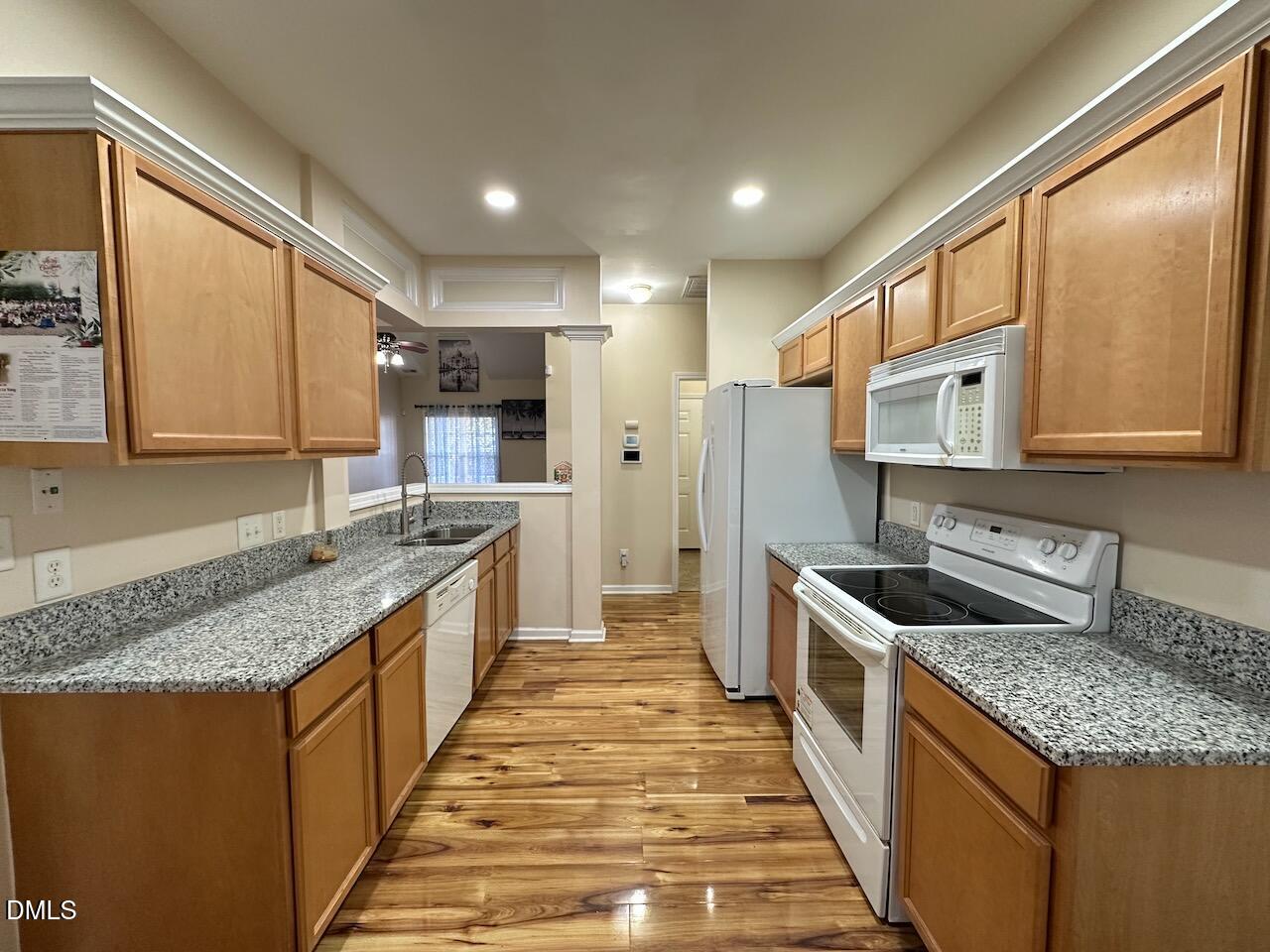 2125 Star Sapphire Drive Raleigh, NC 27610 - Photo 6 of 25 a kitchen with stainless steel appliances granite countertop a sink stove and refrigerator
