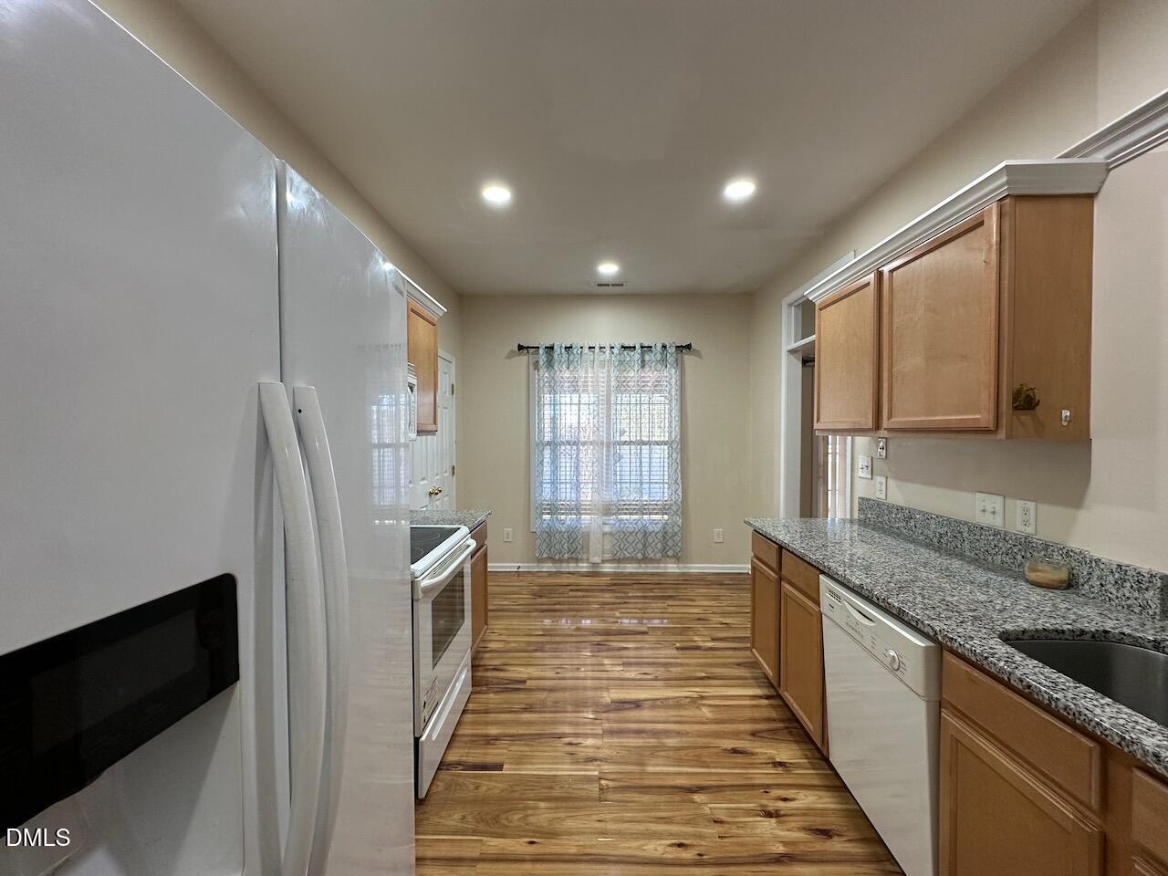 2125 Star Sapphire Drive Raleigh, NC 27610 - Photo 7 of 25 a kitchen with stainless steel appliances granite countertop a refrigerator and a sink