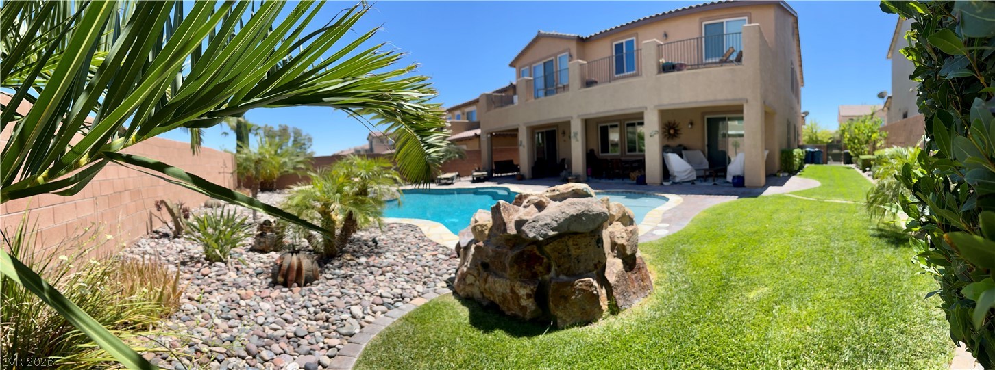 9724 University Ridge Avenue Las Vegas, NV 89149 - Photo 22 of 61 Lush landscaping and a rock-feature pool highlight this property's welcoming backyard.