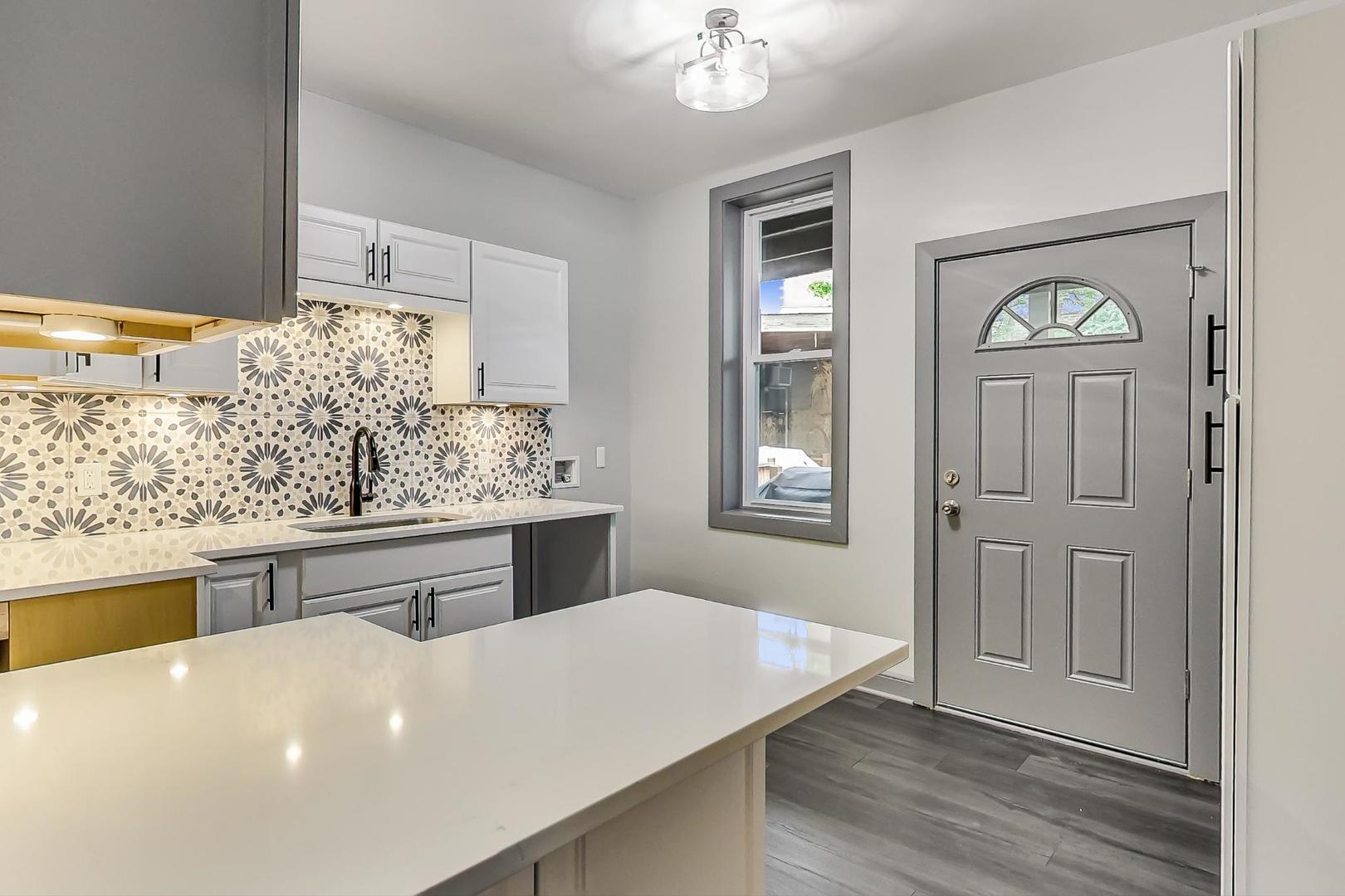 3263 North Broadway, Unit 3 Chicago, IL 60657 - Photo 19 of 37 a kitchen with stainless steel appliances granite countertop a sink stove and refrigerator