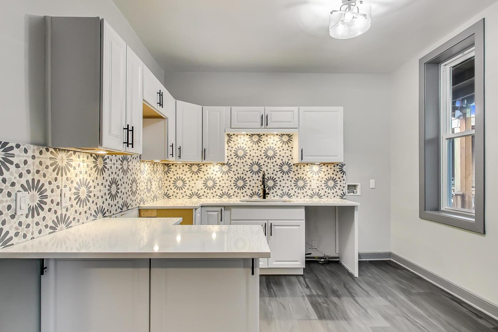 3263 North Broadway, Unit 3 Chicago, IL 60657 - Photo 20 of 37 a kitchen with stainless steel appliances granite countertop a sink and cabinets