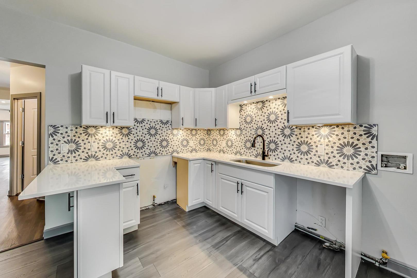 3263 North Broadway, Unit 3 Chicago, IL 60657 - Photo 21 of 37 a kitchen with granite countertop a sink and cabinets