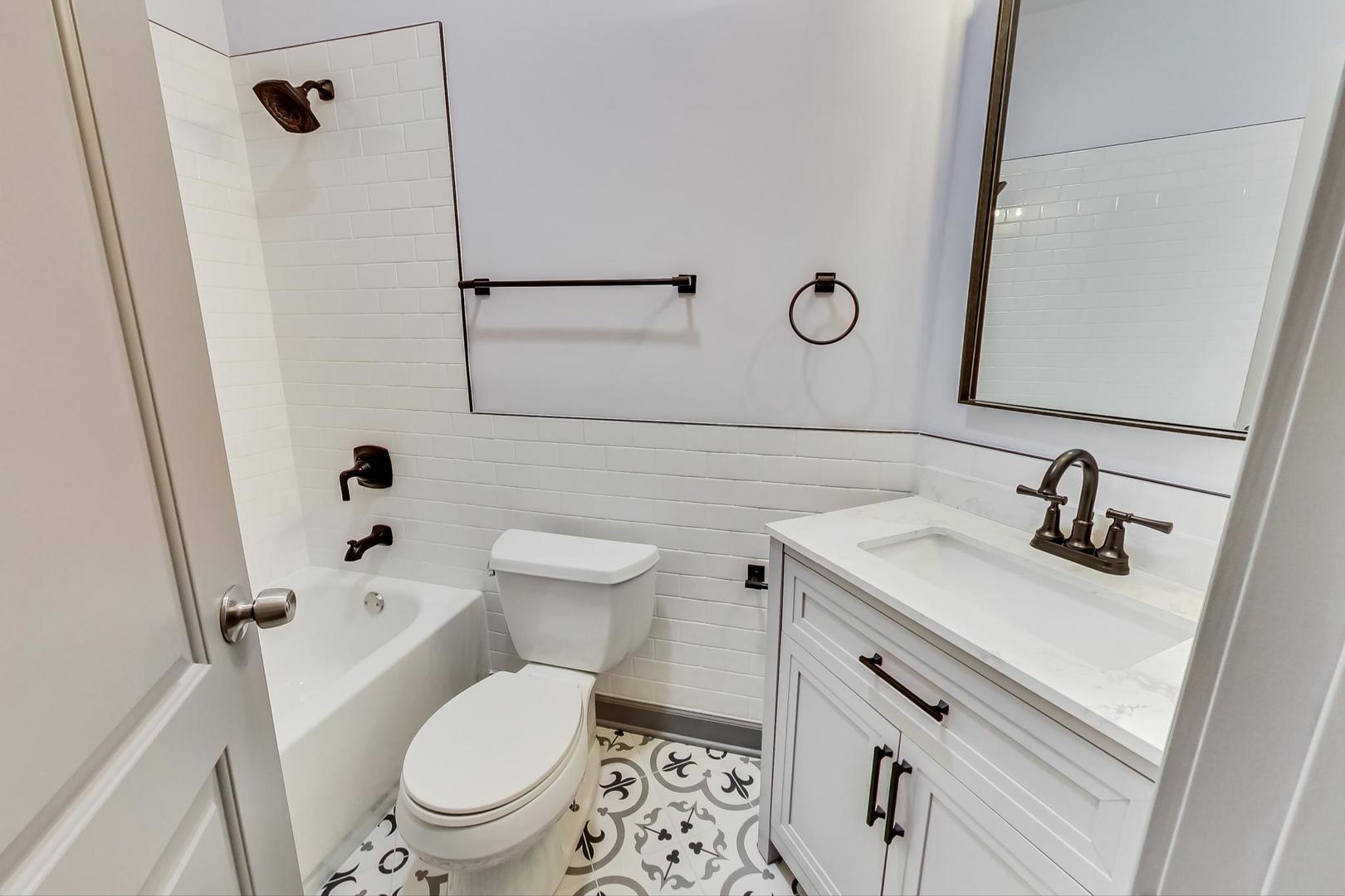 3263 North Broadway, Unit 3 Chicago, IL 60657 - Photo 23 of 37 a bathroom with a toilet sink and mirror