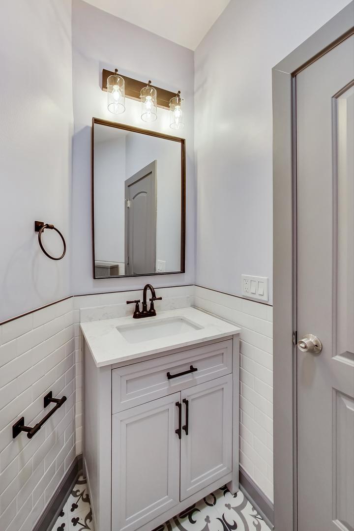 3263 North Broadway, Unit 3 Chicago, IL 60657 - Photo 24 of 37 a bathroom with a sink vanity and mirror