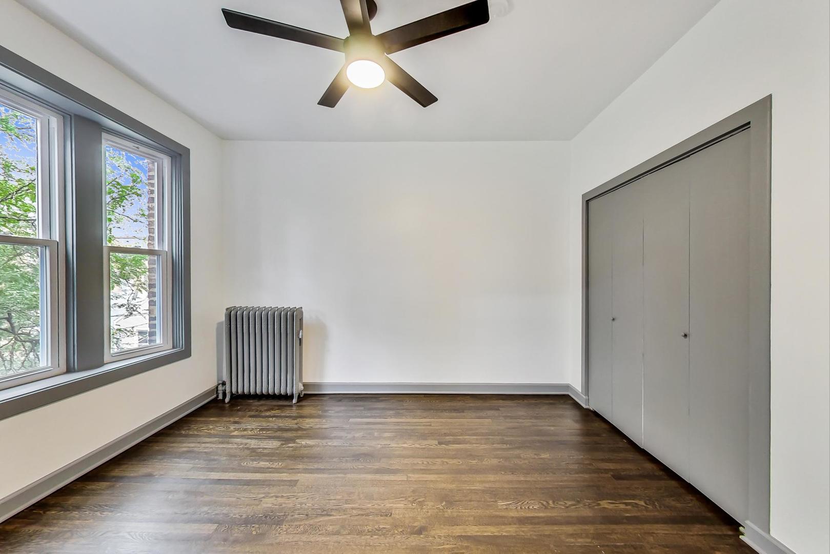 3263 North Broadway, Unit 3 Chicago, IL 60657 - Photo 26 of 37 a view of room with window and wooden floor