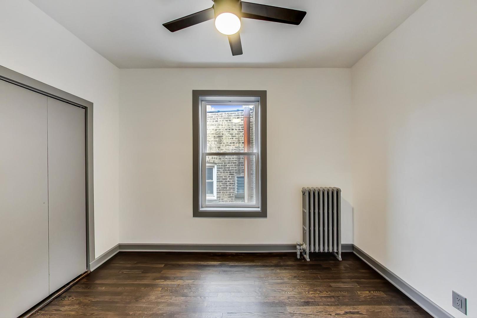 3263 North Broadway, Unit 3 Chicago, IL 60657 - Photo 28 of 37 an empty room with windows