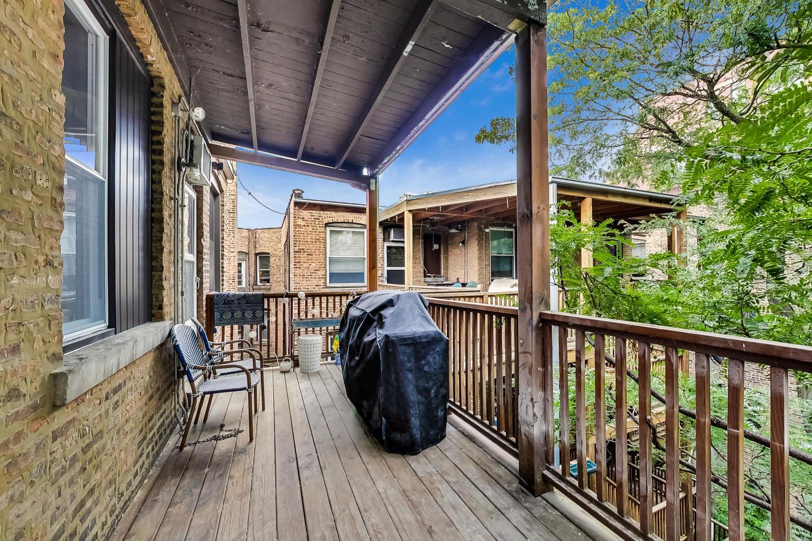 3263 North Broadway, Unit 3 Chicago, IL 60657 - Photo 32 of 37 a view of a balcony with furniture and wooden floor