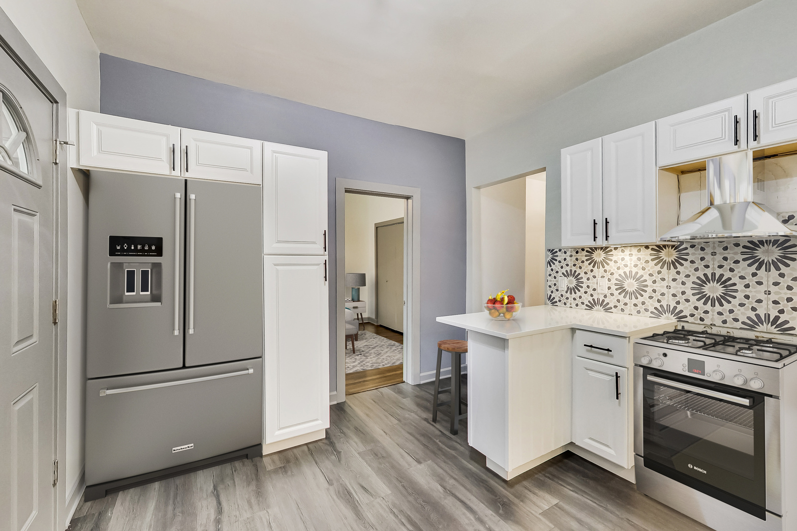 3263 North Broadway, Unit 3 Chicago, IL 60657 - Photo 7 of 37 a kitchen with stainless steel appliances a refrigerator a stove and white cabinets