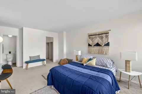 a bedroom with a bed and a painting on the wall