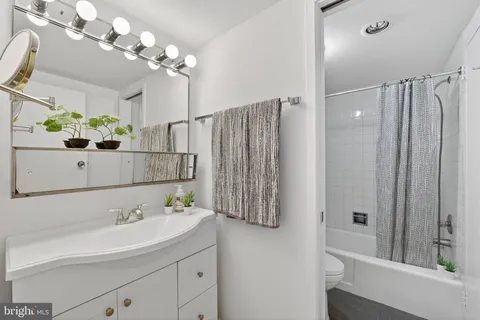 a bathroom with a sink vanity and a mirror