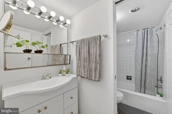 a bathroom with a sink vanity and a mirror