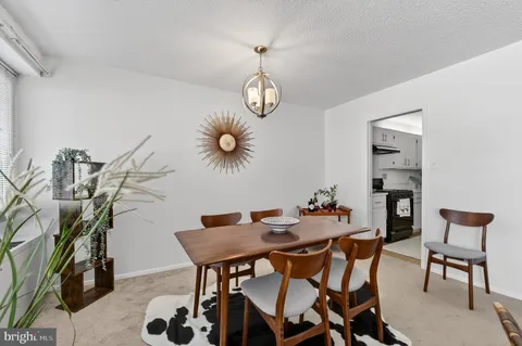 a view of a dining room with furniture and chandelier
