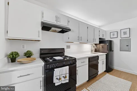 a kitchen with stainless steel appliances a stove a microwave and cabinets