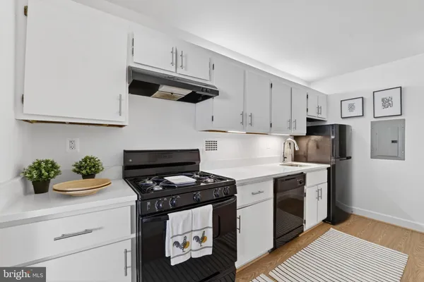 a kitchen with stainless steel appliances a stove a microwave and cabinets