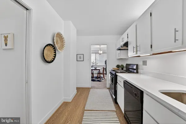 a kitchen with a sink and a refrigerator