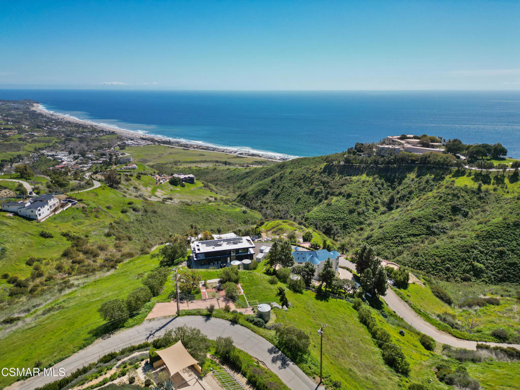 an aerial view of residential building and ocean