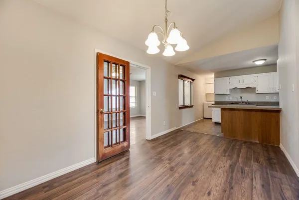 a view of a kitchen with wooden floor and stainless steel appliances