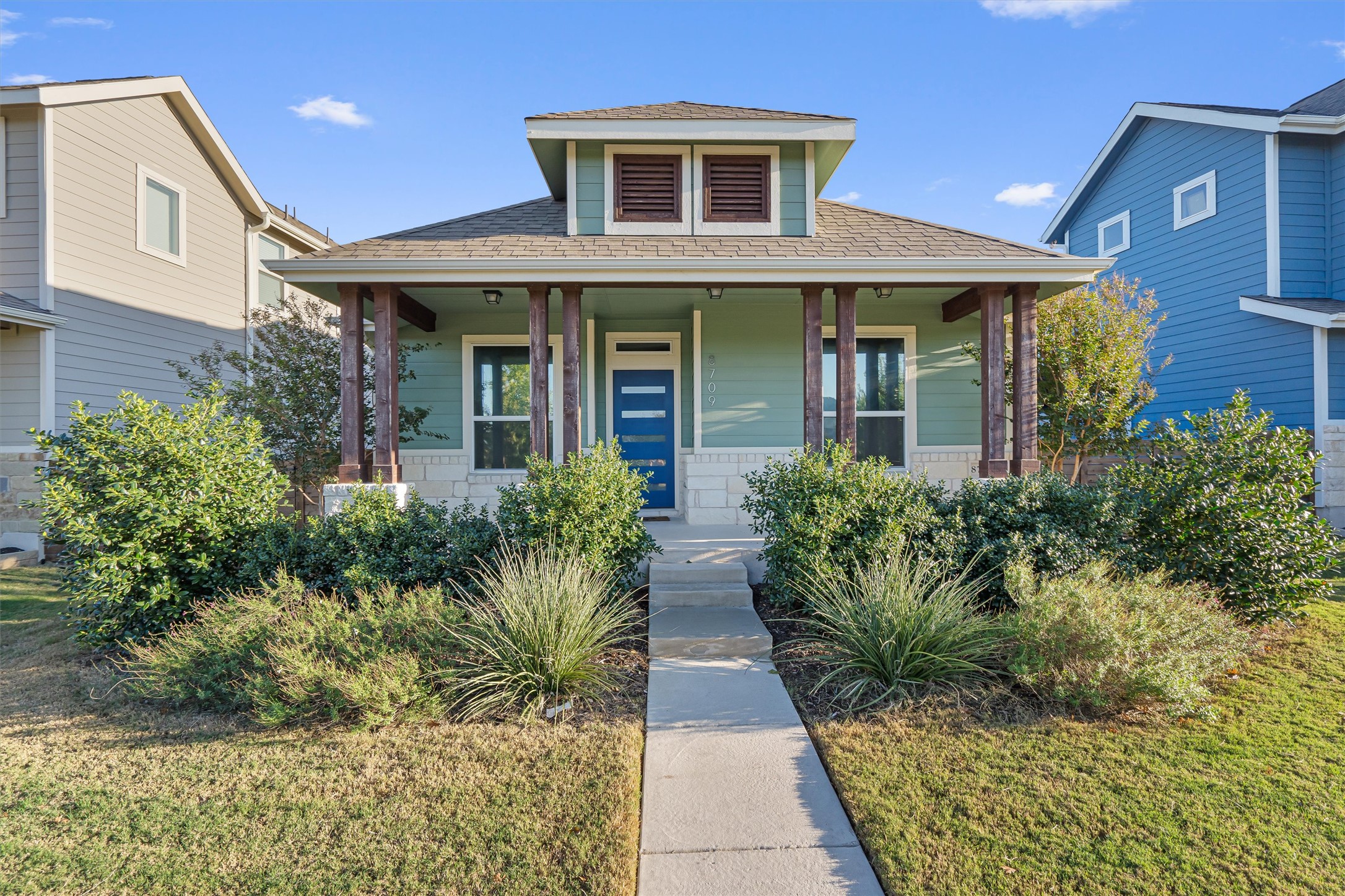 8709 Alderman Dr. Austin, TX 78747 - Photo 1 of 37 Bungalow-style house with a shingled roof, a front lawn, and covered porch