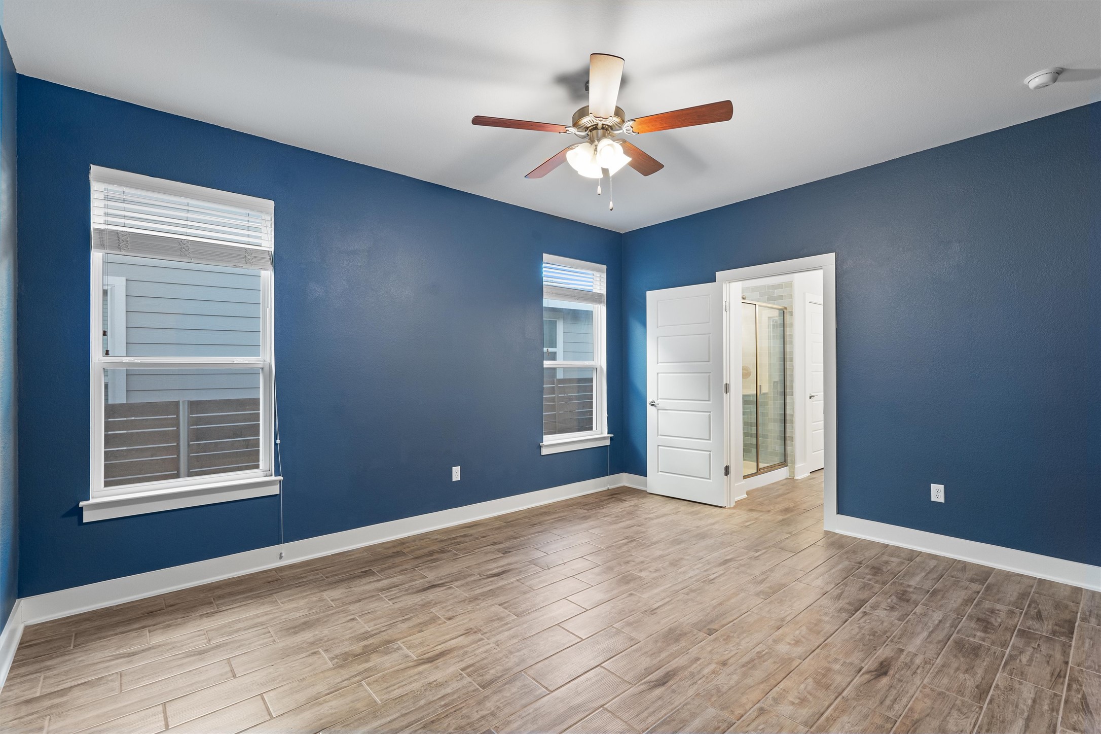 8709 Alderman Dr. Austin, TX 78747 - Photo 16 of 37 Empty room featuring wood finished floors and ceiling fan
