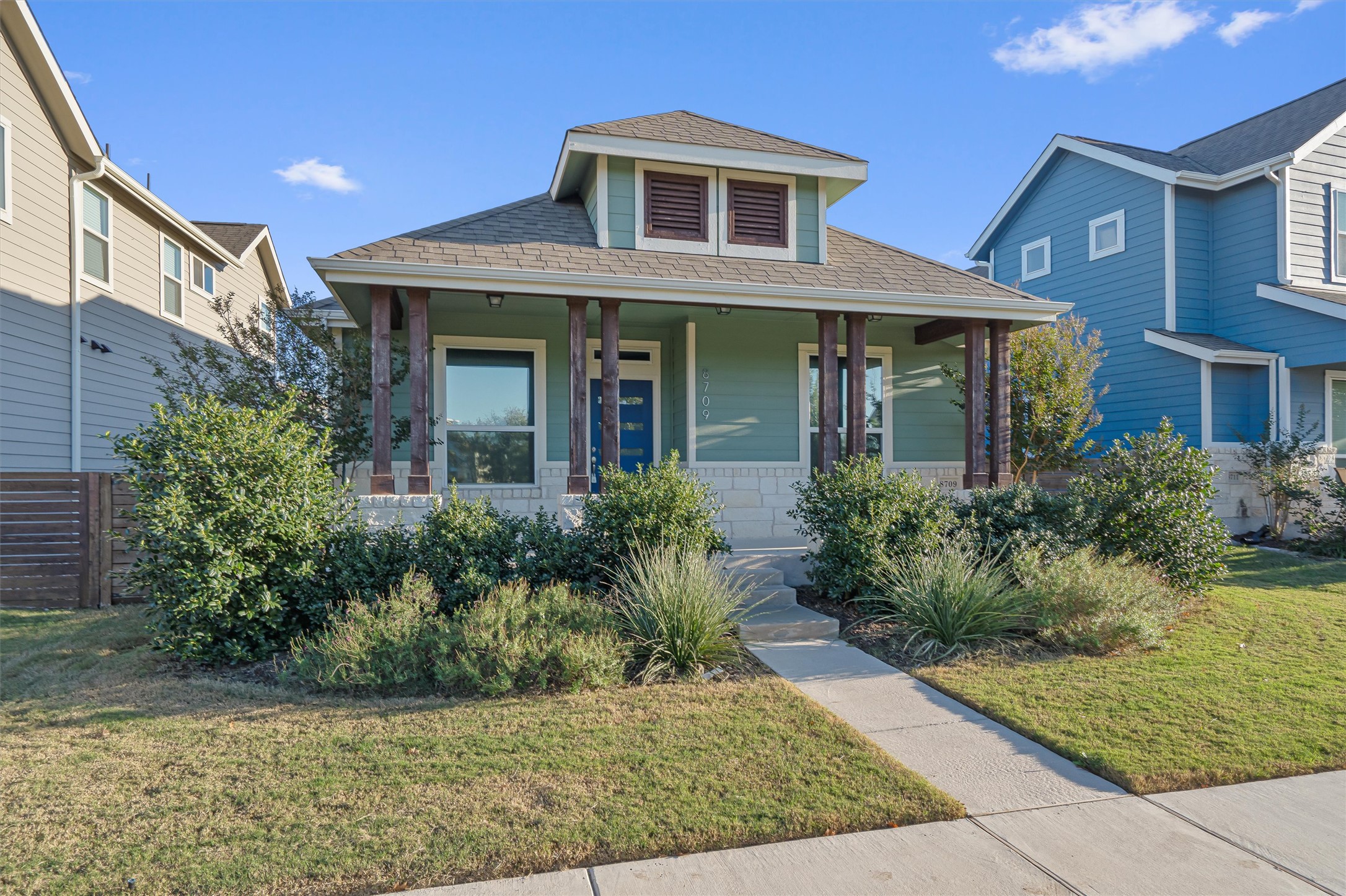 8709 Alderman Dr. Austin, TX 78747 - Photo 2 of 37 Bungalow-style home with roof with shingles, a front lawn, and a porch