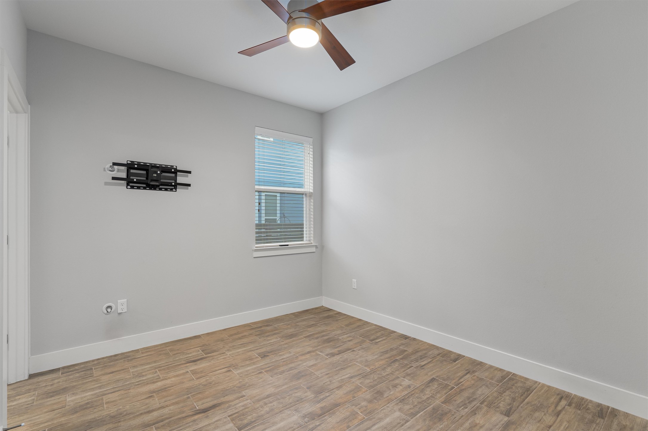 8709 Alderman Dr. Austin, TX 78747 - Photo 23 of 37 Spare room with wood finished floors and ceiling fan