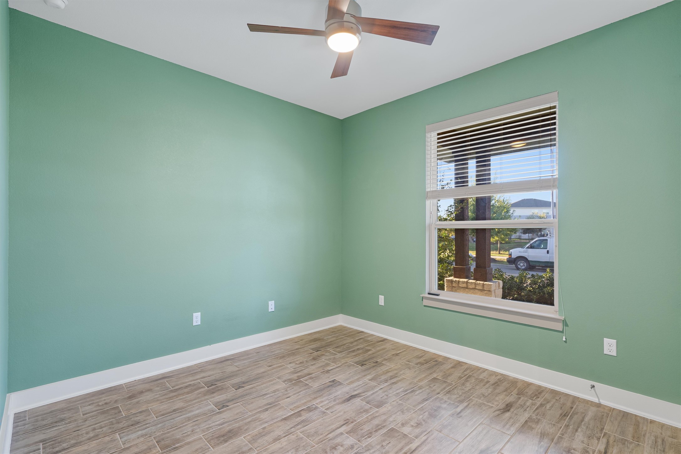8709 Alderman Dr. Austin, TX 78747 - Photo 27 of 37 Empty room featuring wood finish floors and a ceiling fan