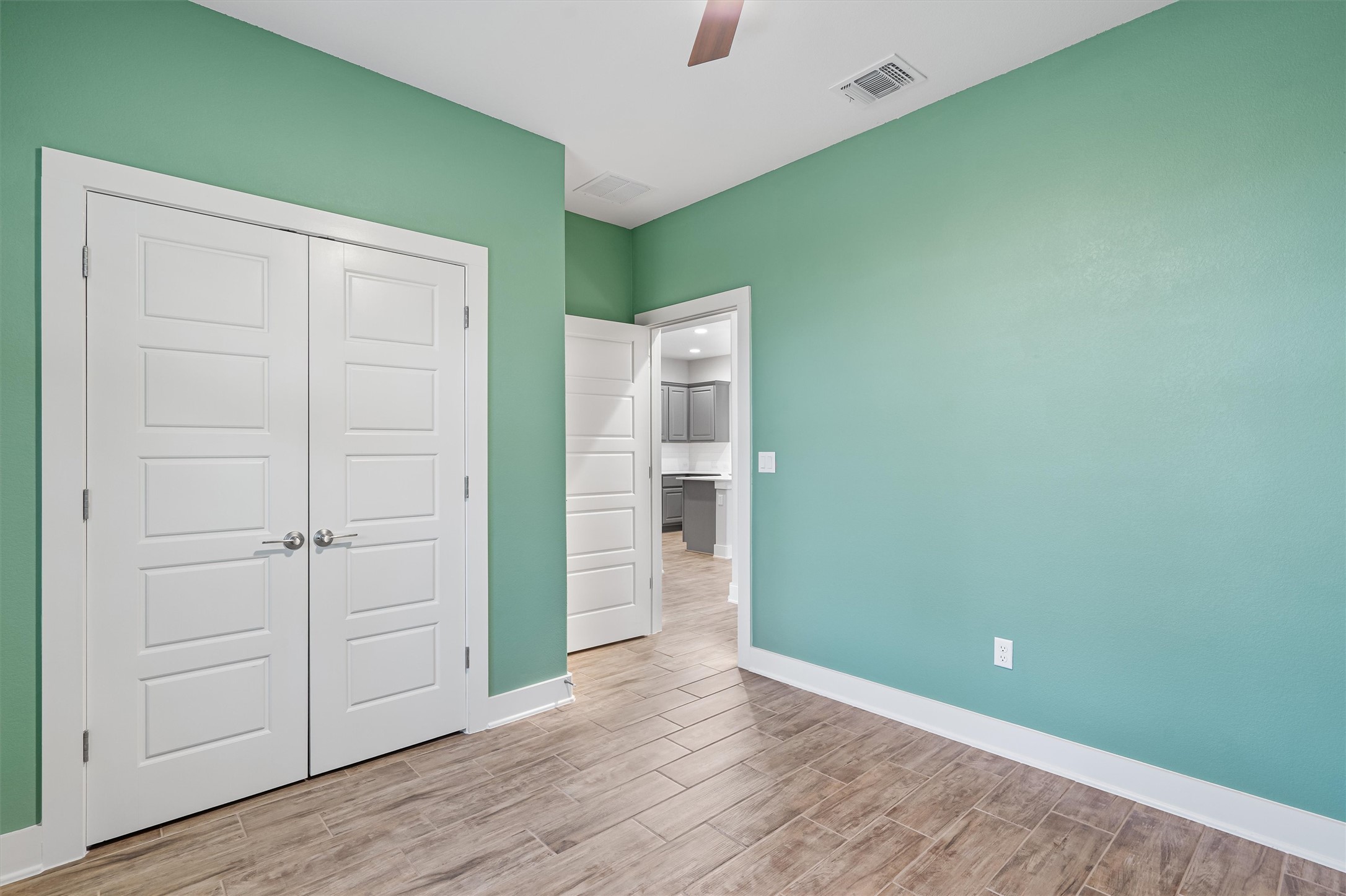8709 Alderman Dr. Austin, TX 78747 - Photo 28 of 37 Unfurnished bedroom featuring wood finish floors, a closet, and a ceiling fan