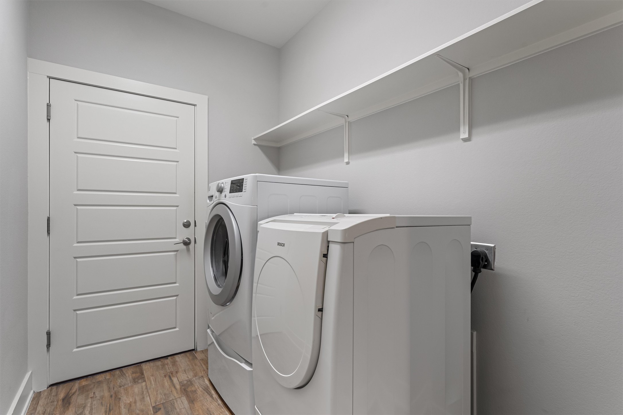 8709 Alderman Dr. Austin, TX 78747 - Photo 30 of 37 Laundry room featuring independent washer and dryer and wood finished floors