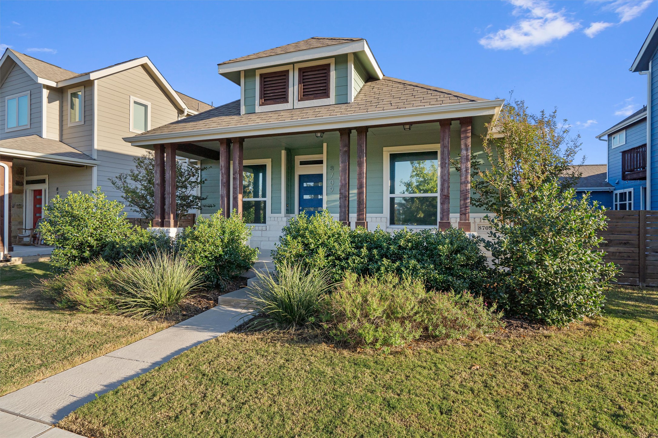 8709 Alderman Dr. Austin, TX 78747 - Photo 3 of 37 Bungalow-style home featuring a shingled roof and a porch