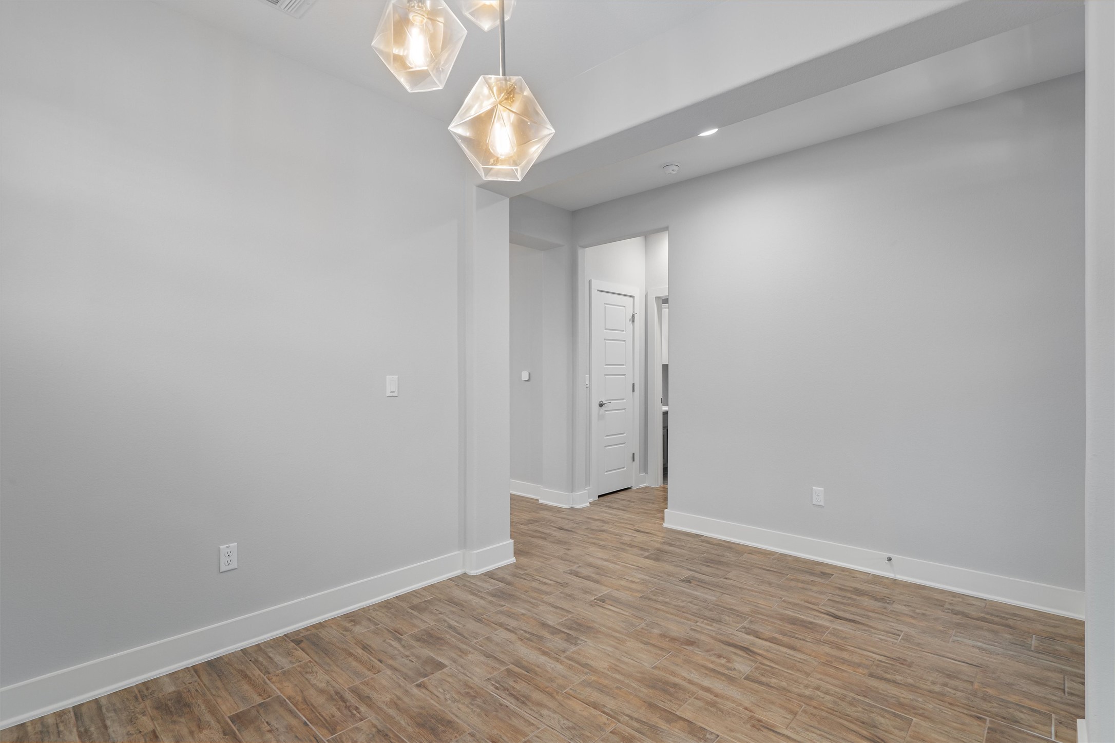 8709 Alderman Dr. Austin, TX 78747 - Photo 7 of 37 Empty room featuring baseboards and light wood-style flooring