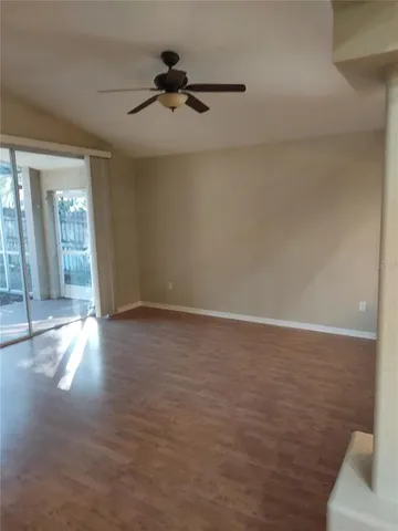 a view of a livingroom with a ceiling fan and window