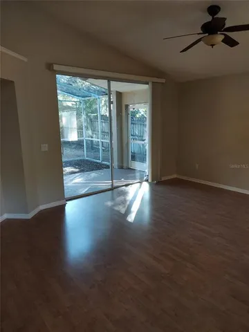 a view of a room with wooden floor and windows