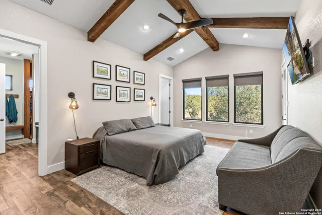 a spacious bedroom with a bed a couch and a window