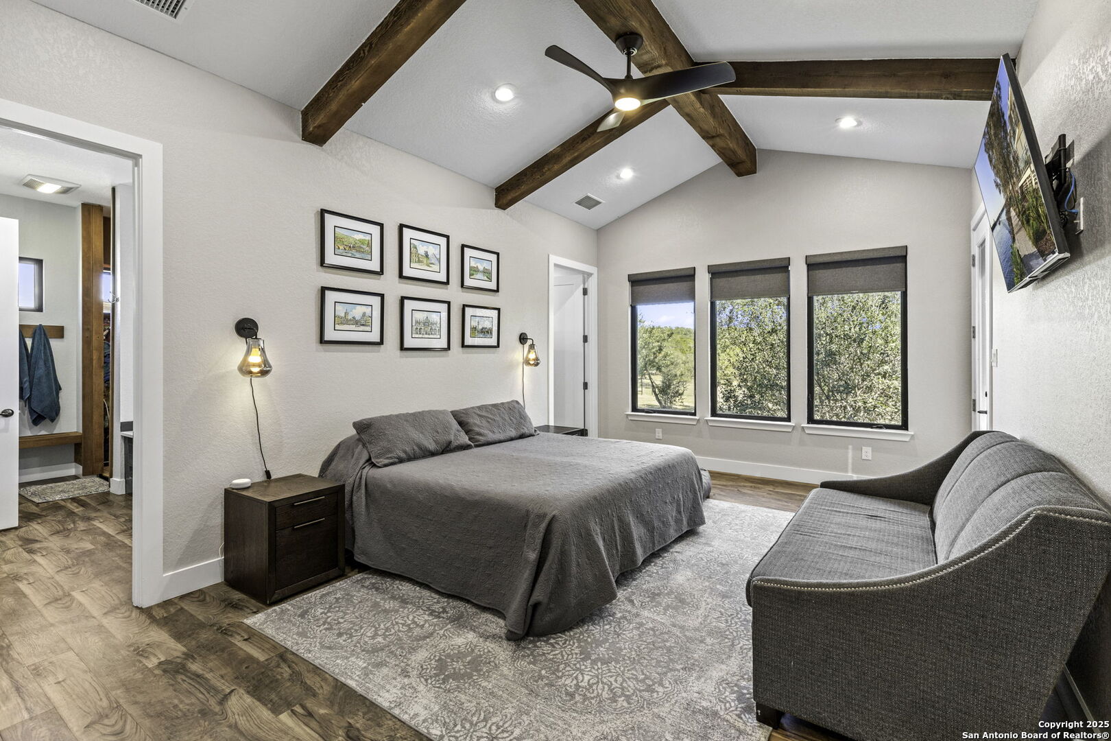 1119 Sunrise Place Spring Branch, TX 78070 - Photo 12 of 53 a spacious bedroom with a bed a couch and a window
