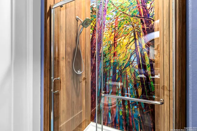 a view of a bedroom with wooden floor and a window