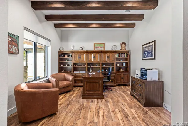 a living room with furniture a flat screen tv and a table