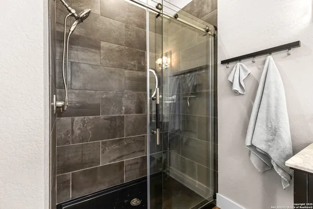 a kitchen with a sink a counter space and wooden floor