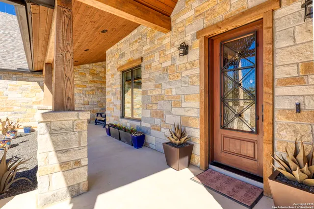 a balcony with furniture and next to a window