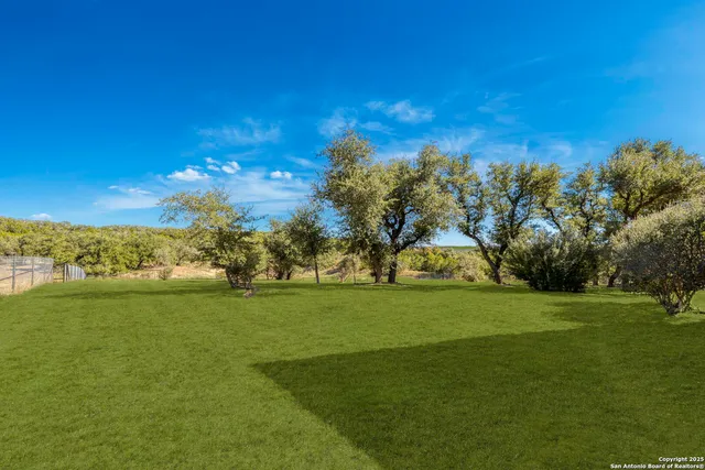 a kitchen with stainless steel appliances granite countertop a refrigerator and a stove