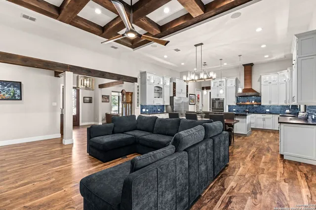 a living room with furniture and kitchen view