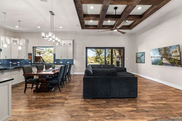 a view of a dining room with furniture and chandelier