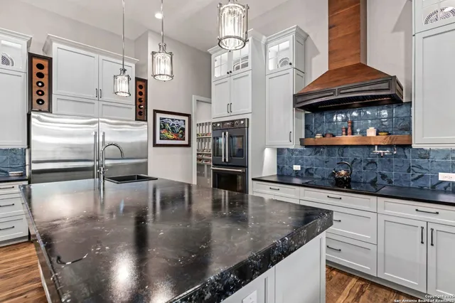 a kitchen with stainless steel appliances granite countertop a stove a microwave and a counter space