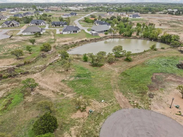 an aerial view of residential houses with outdoor space and river
