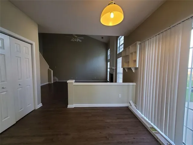 a view of an empty room with wooden floor