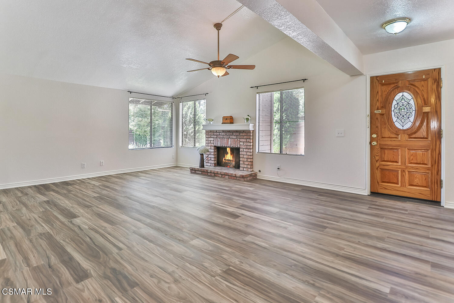 2068 Emory Avenue Simi Valley, CA 93063 - Photo 12 of 35 an empty room with wooden floor chandelier fan and windows