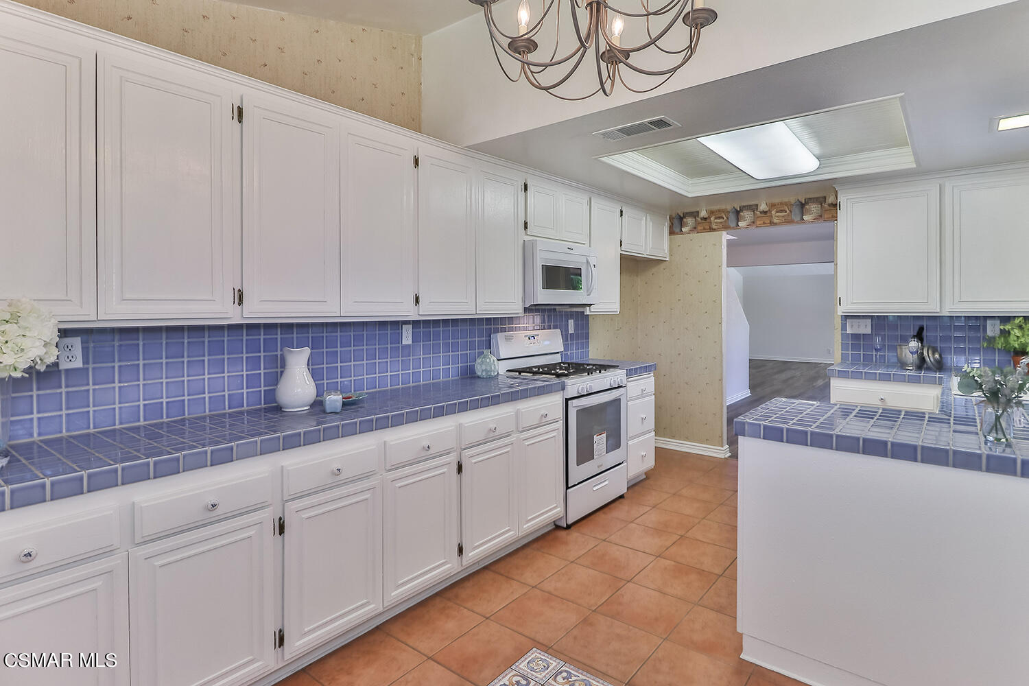 2068 Emory Avenue Simi Valley, CA 93063 - Photo 18 of 35 a kitchen with kitchen island granite countertop a sink a counter space and cabinets