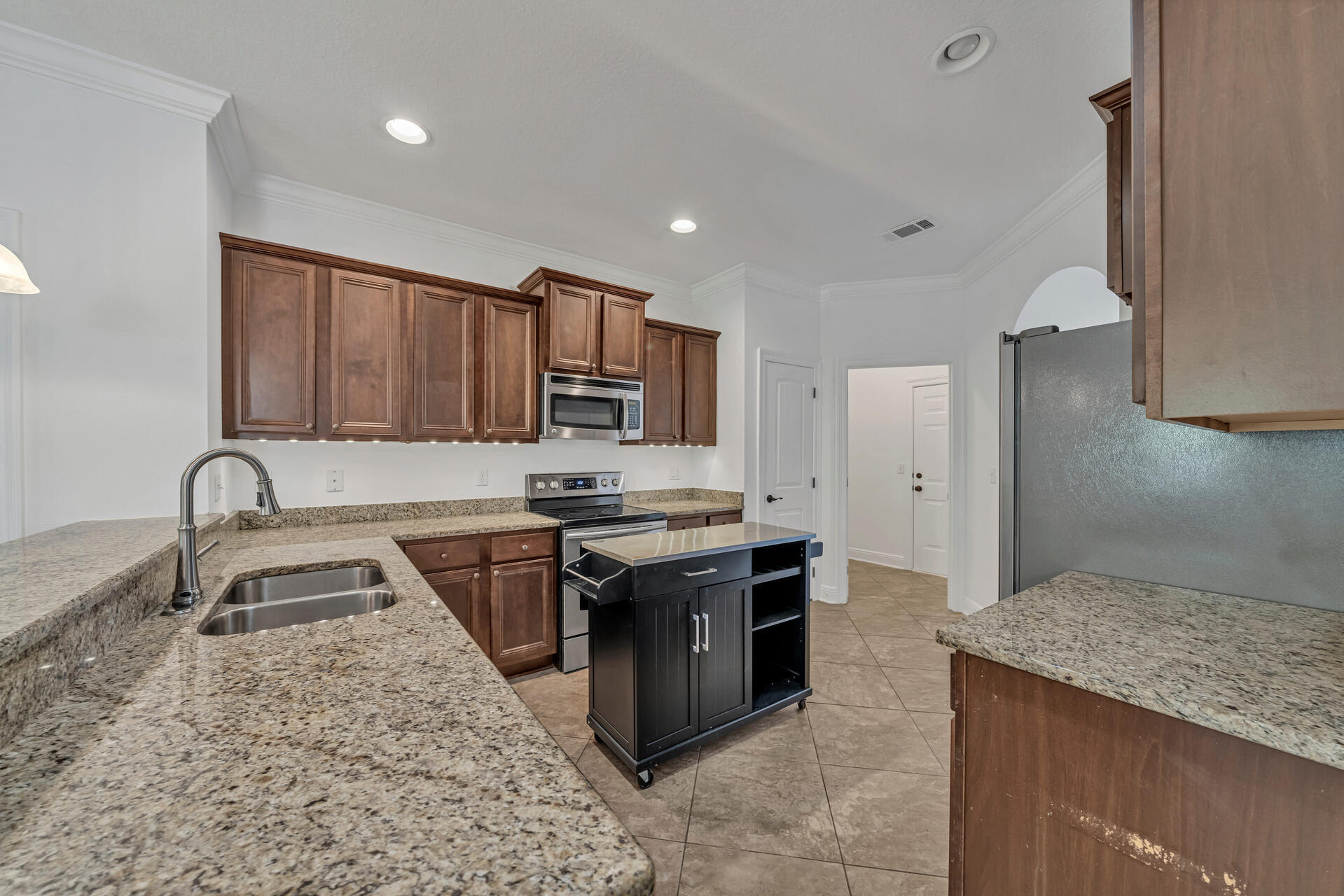 137 Lullaby Loop Santa Rosa Beach, FL 32459 - Photo 14 of 33 a kitchen with stainless steel appliances granite countertop a sink stove and refrigerator