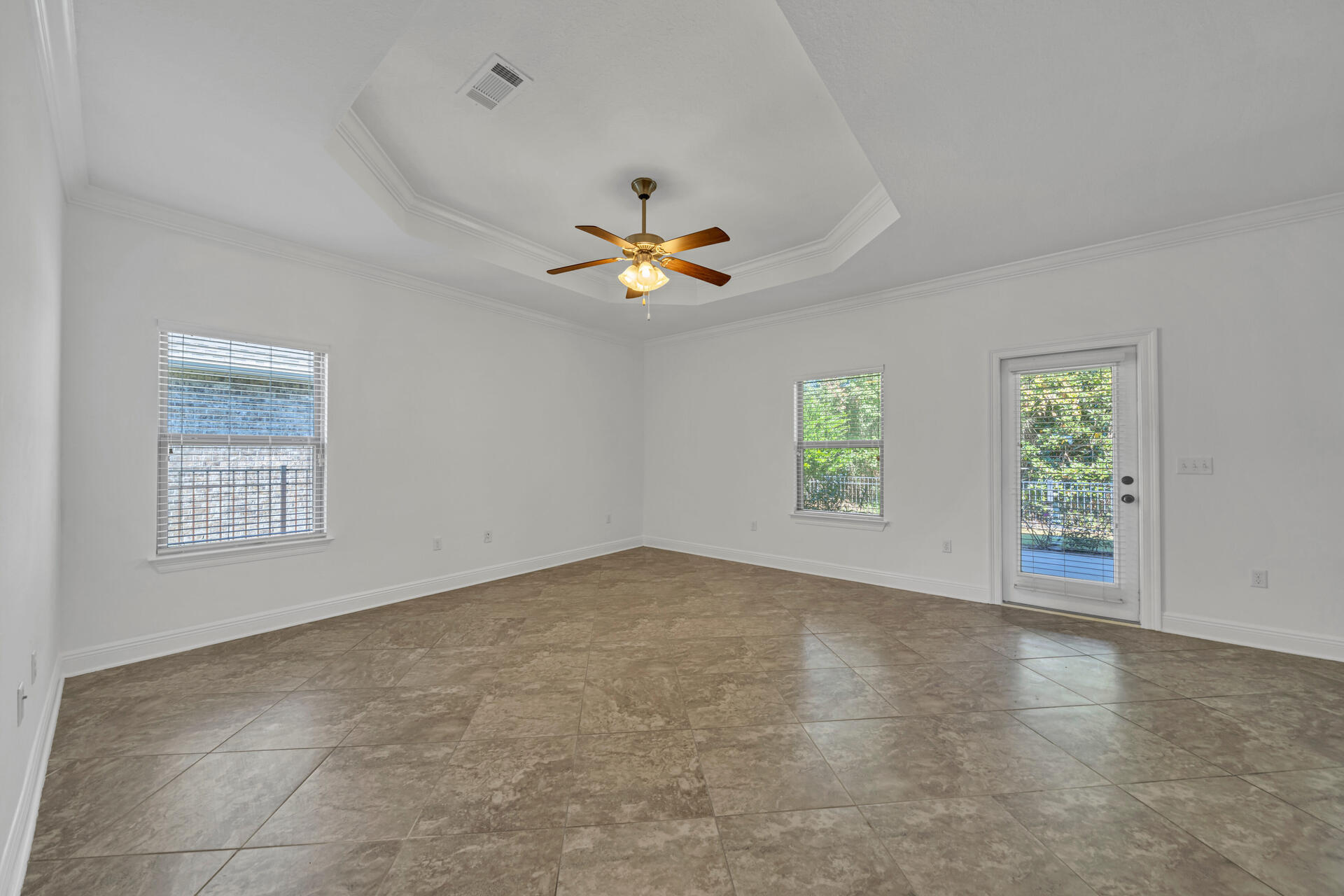 137 Lullaby Loop Santa Rosa Beach, FL 32459 - Photo 18 of 33 an empty room with windows and chandelier fan